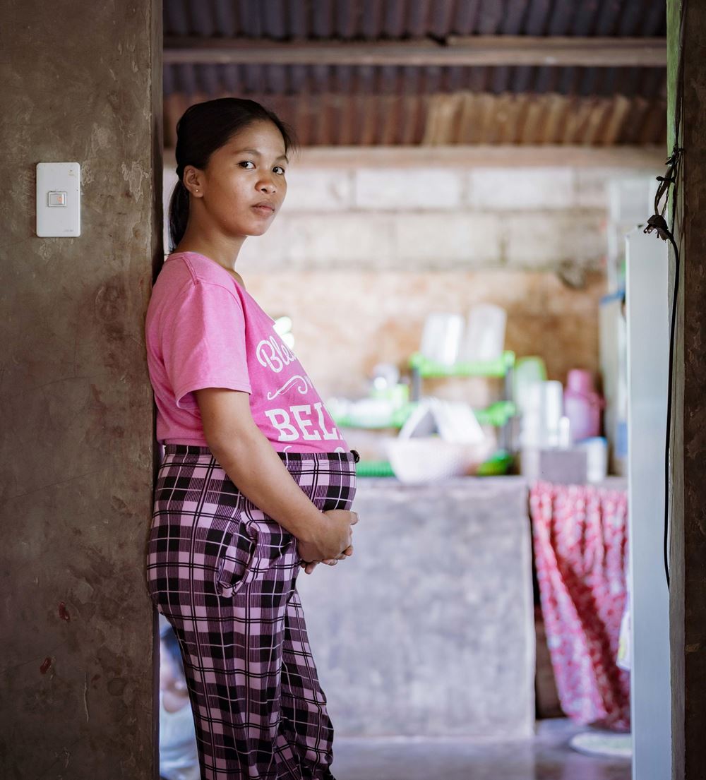 Ein schwangeres Mädchen steht in einer Türöffnung (Quelle: KNH/Jakob Studnar)
