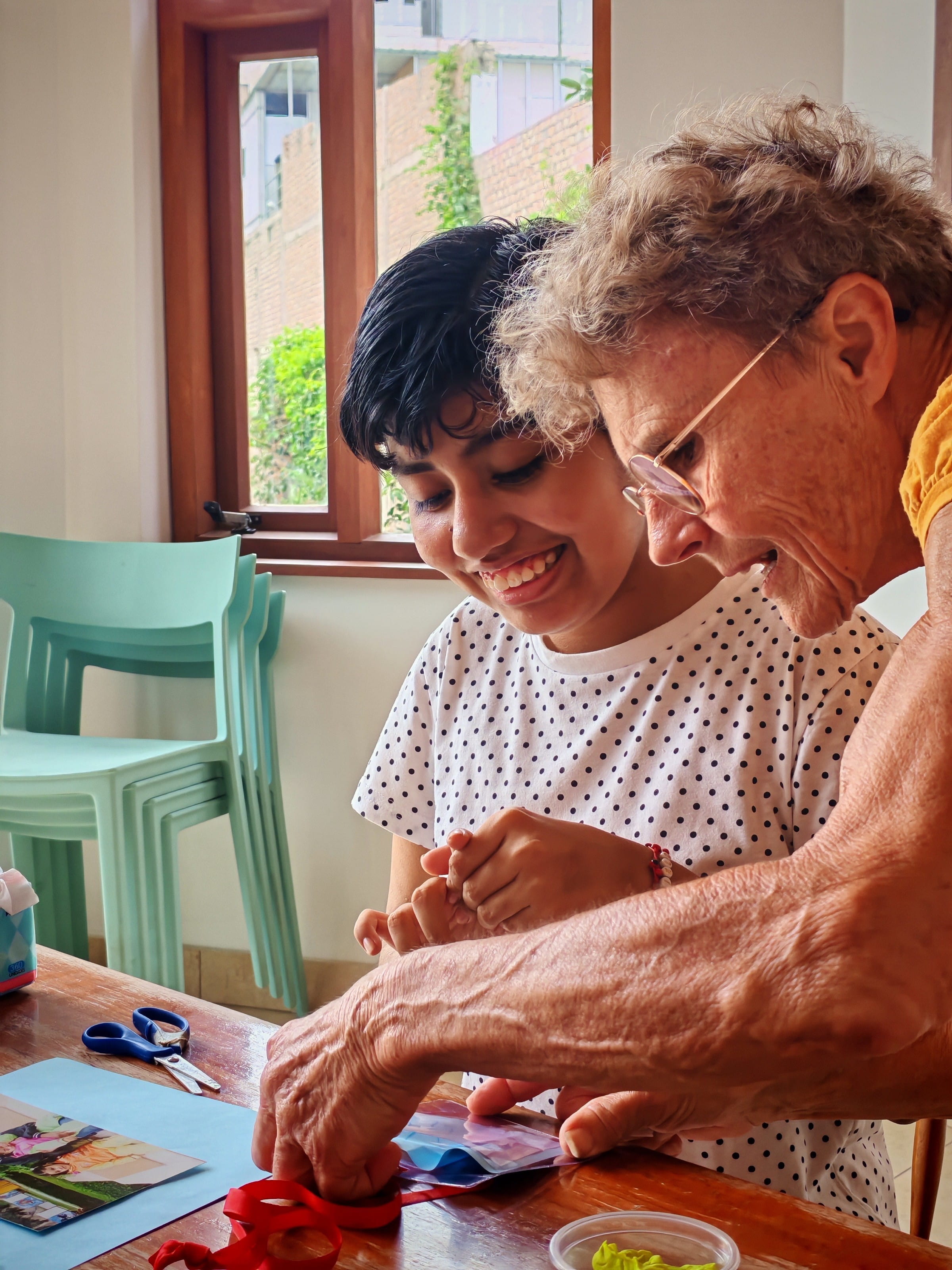 Ilse Kreiner bastelt mit einem Kind im Projekt Aynimundo in Lima, Peru. (Foto: Christian Delgado Linares)